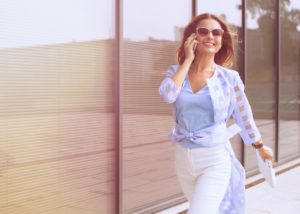 woman on her cellphone walking down street